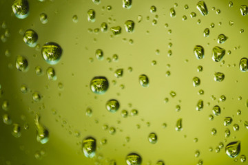Drops on the glass. Reflection of trees in the garden in every drop of rain.