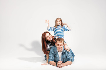 Fototapeta na wymiar Happy family portrait lying on white background isolated