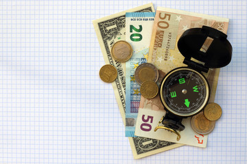 Composition - compass money on a checkered sheet background