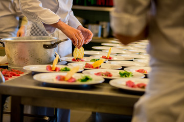 Preparing carpaccio dishes during a catering party