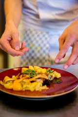 Finishing a dish in a restaurant kitchen