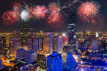 Bangkok Cityscape in Business district and high building at night with celebration fireworks.