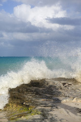Wave hitting the rocks on the shore. Water splash. Powerful wave.