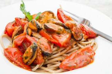 white dish with Pasta spaghetti , mussel and tomatoes