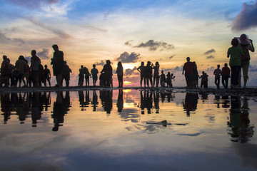 beautiful silhouette of Photographers and Tourist photographing the sunset at Kuta beach, Bali,...