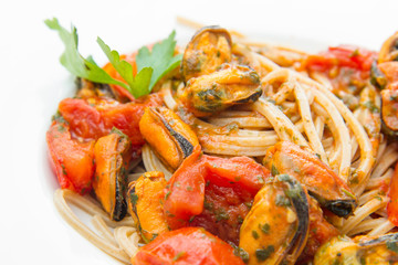 white dish with Pasta spaghetti , mussel and tomatoes