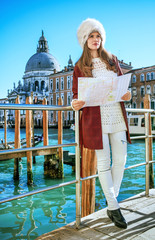 Fototapeta na wymiar tourist woman on embankment in Venice exploring attractions