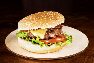 Hamburger with barbecue sauce on a cutting board