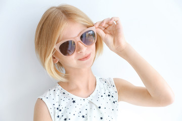 Portrait of attractive teenager girl  in sunglasses on white background