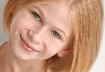 Closeup portrait of attractive teenager girl with freckles