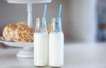 Table with bottles of milk and dessert stand