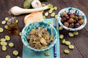 Bowl with fave in wet with onion and oregano and zucchini