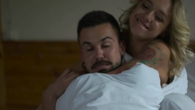 Couple hagging in the bed.