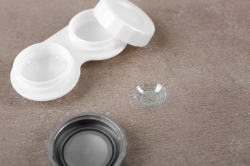 Contact lens and case on table