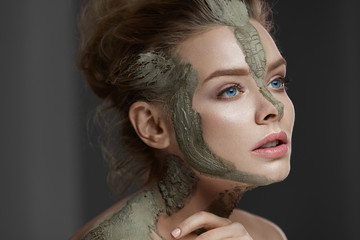 Skin Care. Young Woman With Clay Mask On Face And Body