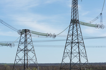 High-voltage power lines against the blue sky.