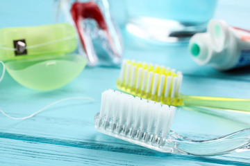 Toothbrushes on color wooden background, closeup