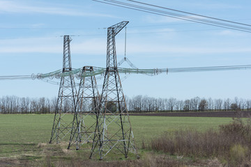High-voltage power lines against the blue sky.