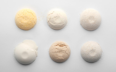 Different types of flour on white background