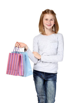 Cute girl with paper bags on white background