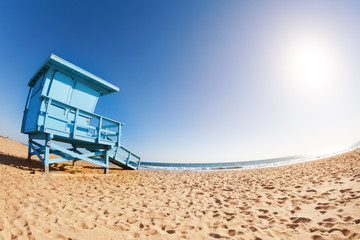 Fototapeta premium Deserted sea shore with wooden lifeguard tower