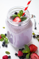 Berry milkshake on white.