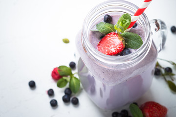 Berry milkshake on white.