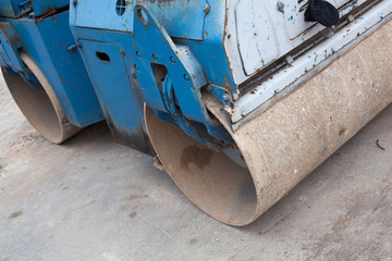 Fototapeta premium Blue construction road roller. A large and powerful blue road roller on the construction site.