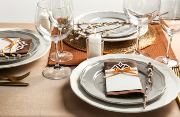 Beautiful table setting with golden cutlery