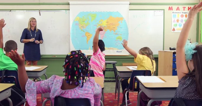 Teacher in front of class asking math questions