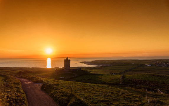 aerial view of an old irish castle sunset in doolin county clare, ireland
