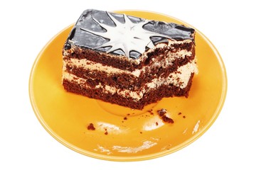 Bitten chocolate cake on orange plate