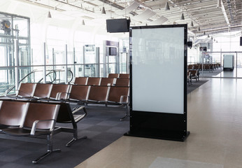 empty airport terminal waiting area with chairs.