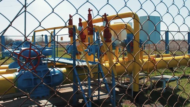 Gas cleaning station. Tanks and pumps for storing natural gas. Engineering design. System for transporting gas and oil through pipes. Pressure sensors and shut-off valves.