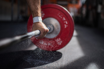 Fototapeta Man Weightlifter Lifts a Barbell weight In a Gym obraz