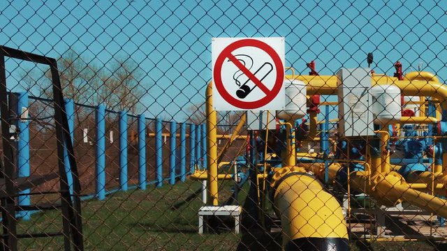 Oil and gas industry. Extraction and transportation. no smoking. Danger of using fire. pumping station. Transportation and storage of natural gas and oil. Pipeline with a manometer and a shut-off