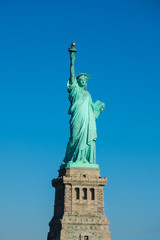 Fototapeta na wymiar Statue of Liberty at perfect weather conditions blue sky copper