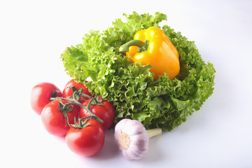 Fresh assorted vegetables bell pepper, tomato, garlic with leaf lettuce. Isolated on white background. Selective focus.