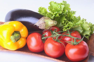 Fresh assorted vegetables, eggplant, bell pepper, tomato, garlic with leaf lettuce. Isolated on white background. Selective focus.
