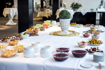 Variety of fresh salads bowls on buffet table business dinner