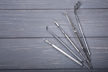 Set of dentist tools on wooden background