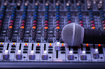 Microphone,Professional audio mixing console buttons,faders and sliders.