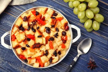 Delicious bread pudding with fruits on table