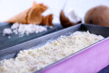Container with fresh coconut ice cream, closeup
