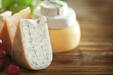 Variety of cheese on wooden table
