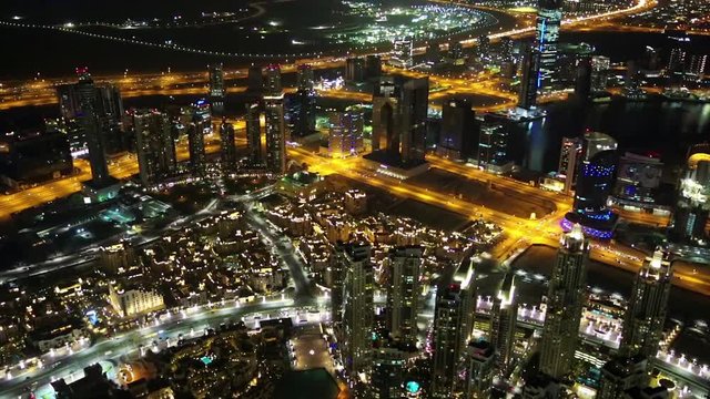 Dubai downtown at night, United Arab Emirates. Top view from the 124th floor of Burj Khalifa skyscraper in Dubai, currently the tallest structure in the world, 829,8 m. At the top - Burj Khalifa