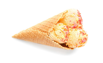 Delicious ice cream with sprinkles in waffle cone on white background