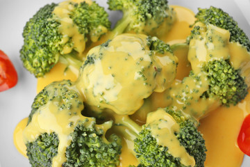 Plate with broccoli and cheese sauce, closeup