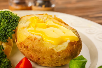Baked potato with cheese sauce, closeup