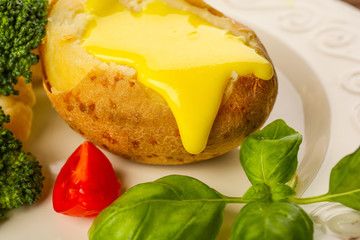 Baked potato with cheese sauce, closeup